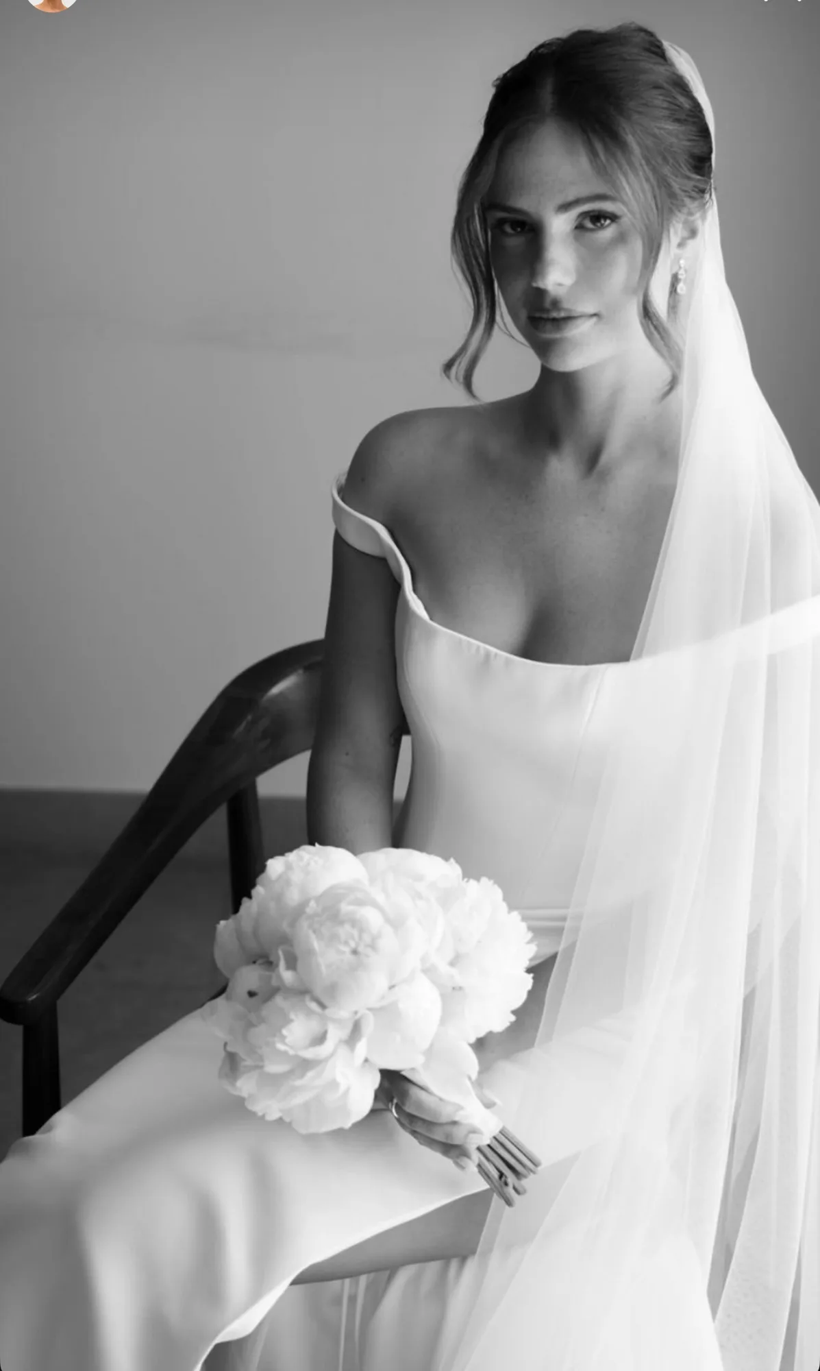 Mariée en noir et blanc avec un bouquet de pivoines blanches