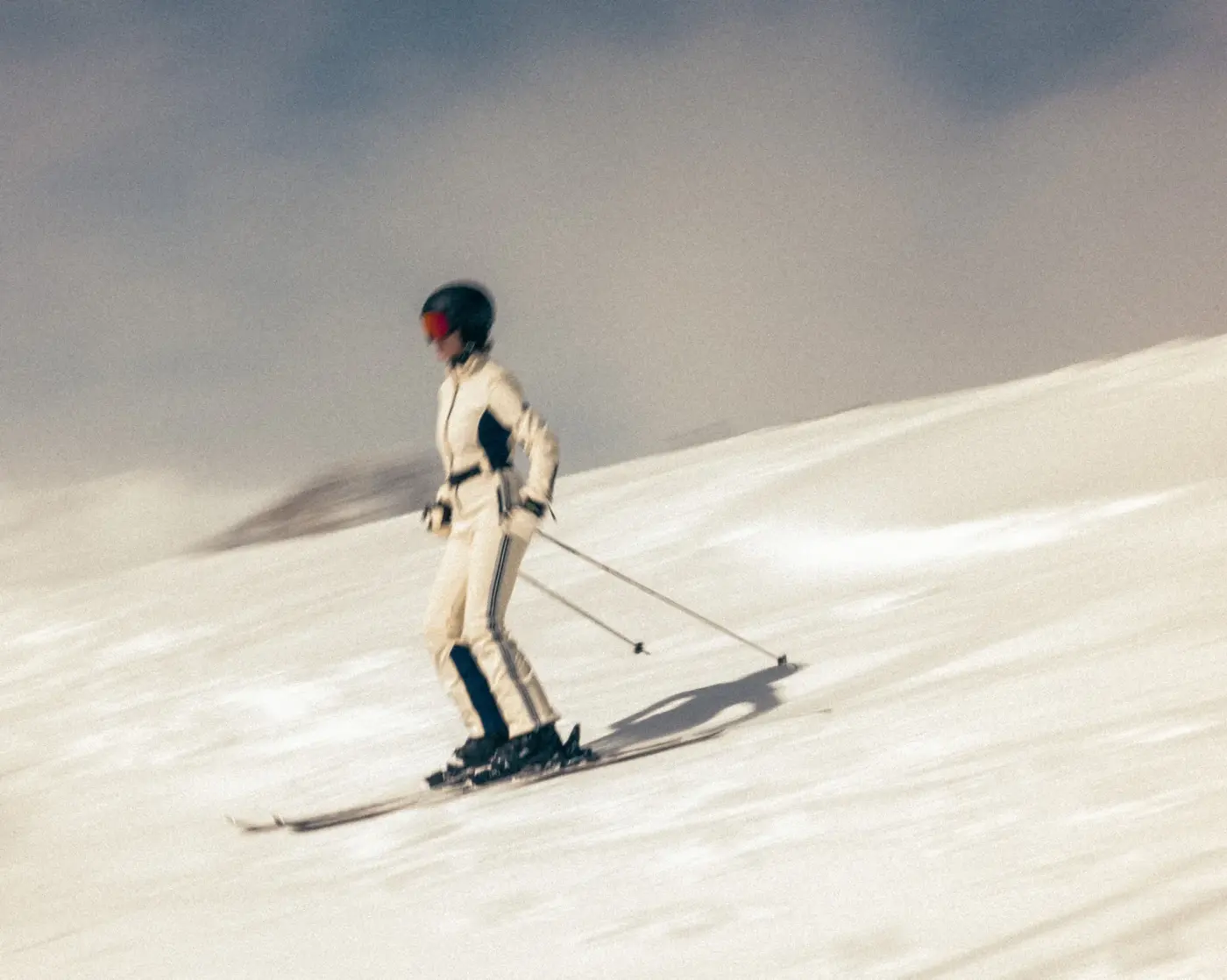 Skier in a white ski suit